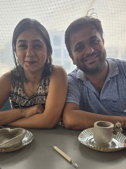 A beautiful memory captured. This couple proudly displays the pieces they sculpted, a perfect souvenir from their creative date activity in Mumbai.