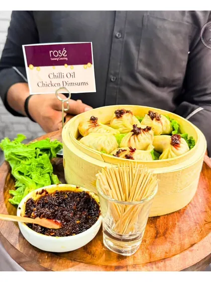 Our Chilli Oil Chicken Dimsums are a perfect blend of spice and succulence. Served in a bamboo steamer with our house-made chili oil, they are a highlight of our Pan-Asian menu.