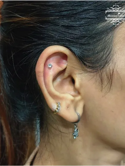 A conch piercing is a unique and stylish choice. We use a sterile needle to ensure it's placed perfectly in the inner part of the ear for a subtle yet impactful look.