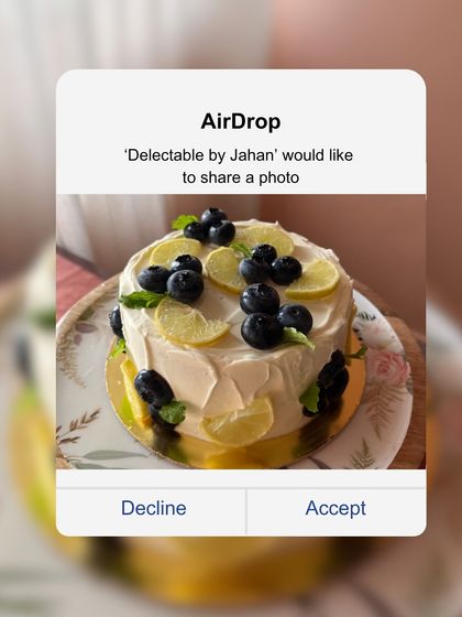 A beautiful vanilla sponge cake with lemon zest, filled with homemade blueberry jam and lemon curd. It's topped with fresh lemon slices and blueberries for a bright, fresh look.