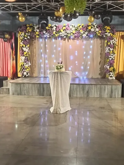 A simple yet elegant stage setup with a beautiful cake, ready for the celebration to begin.
