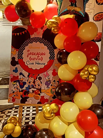 A closer look at the welcome sign and balloon arrangement for the Mickey Mouse party. The combination of red, yellow, black, and gold balloons created a classic and cheerful vibe.
