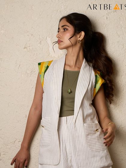 A closer look at the Greener Co-ord set. The pinstriped handwoven cotton provides a neutral base for the vibrant yellow and green artwork on the shoulders, creating a perfect balance.