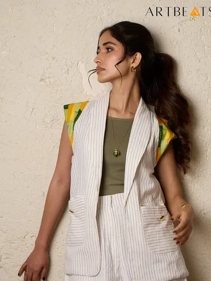 A closer look at the Greener Co-ord set. The pinstriped handwoven cotton provides a neutral base for the vibrant yellow and green artwork on the shoulders, creating a perfect balance.