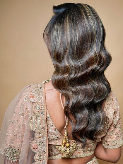 A view from the back, focusing on the beautiful cascade of waves, a popular choice for modern brides.