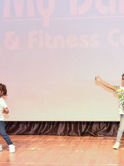 Two of our little dancers performing a duet piece. Our classes also teach them how to coordinate and dance with a partner.