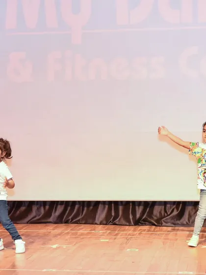 Two of our little dancers performing a duet piece. Our classes also teach them how to coordinate and dance with a partner.