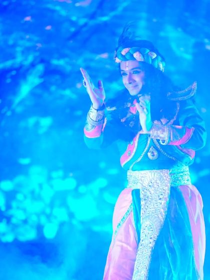 A visually striking image of my portrayal of Krishna from '18 Days', set against a backdrop of cosmic energy. We use multimedia projections to enhance the storytelling and create a larger than life experience.