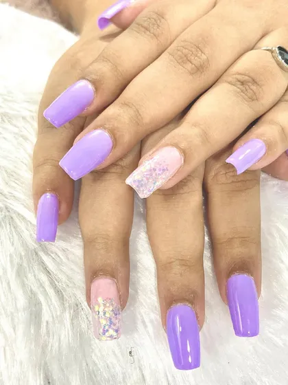 Stunning lilac nails. This set features long, square-shaped extensions in a beautiful lavender purple with iridescent glitter accents.