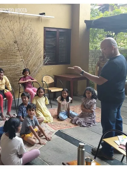 A storyteller engages with a group of children in our outdoor courtyard space. We use all parts of our venue to create magical experiences.