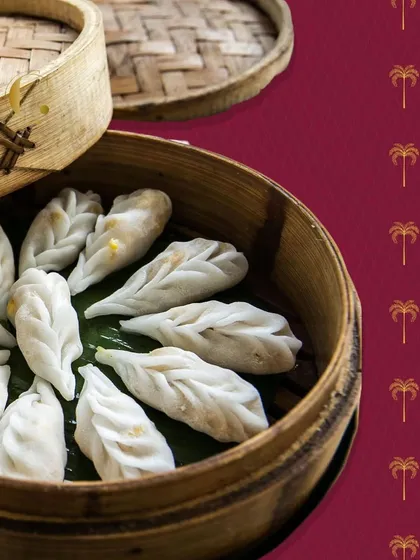 Beautifully pleated vegetarian momos resting in a bamboo steamer. These bite-sized delights are a testament to the craft and skill of our chefs in creating authentic global dishes.