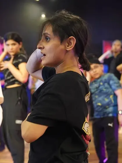 The instructor guiding her students through a challenging piece.