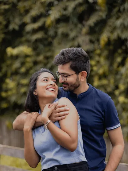 A loving gaze shared between the couple against a soft, natural background. This classic portrait is all about capturing the adoration and connection in their eyes.
