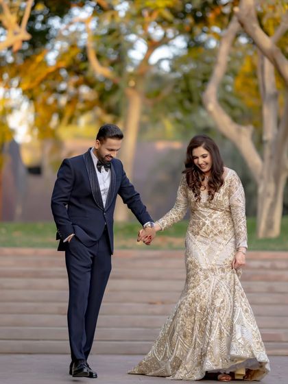 A candid moment of shared laughter as they walk hand-in-hand. This photo perfectly captures the fun and relaxed vibe of their pre-wedding celebration.