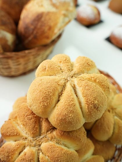 A close-up of beautifully shaped and scored bread rolls from our international bread class. The scoring is not just for looks; it helps the bread expand correctly.