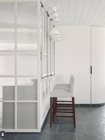 From the archives, a project celebrating Indian materials. Here, we used beautiful Kota stone for the flooring, paired with a minimalist white bar and curved architectural details.