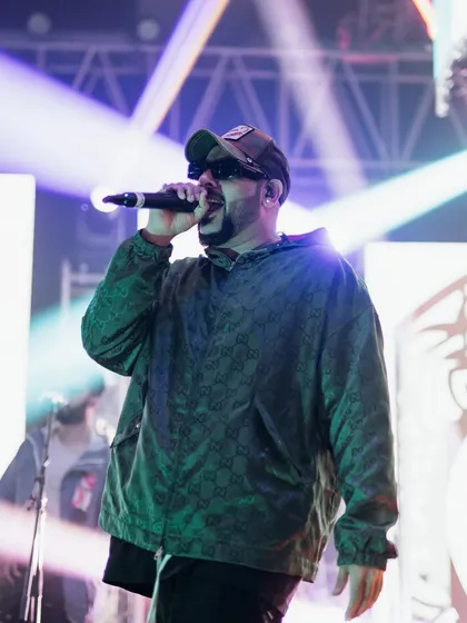 A celebrity artist performing on stage. Our 7-year journey has been about managing every detail, including complex artist logistics, to deliver flawless entertainment.