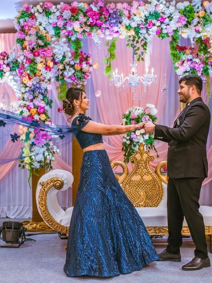 And forever starts now. A picture-perfect dance moment from the reception, showcasing the bride's stunning blue lehenga and elegant updo in action.