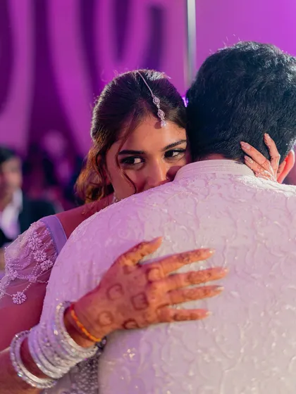 A stolen glance during a slow dance. This intimate, candid moment captures the deep connection between the couple amidst the lively Sangeet atmosphere.