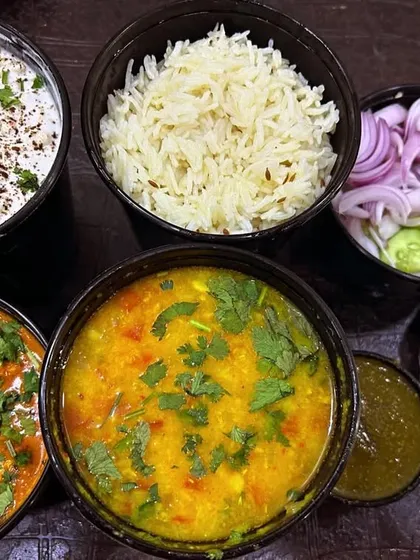 This is a typical weekend order from my customers. It has everything you need: Raita, Kadai Paneer, Dal, Rice, and Roti.