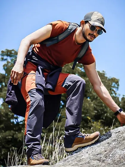 Navigating a steep rock face during our Shivagange trek. I always ensure safety while guiding you through more technical parts of the trail.