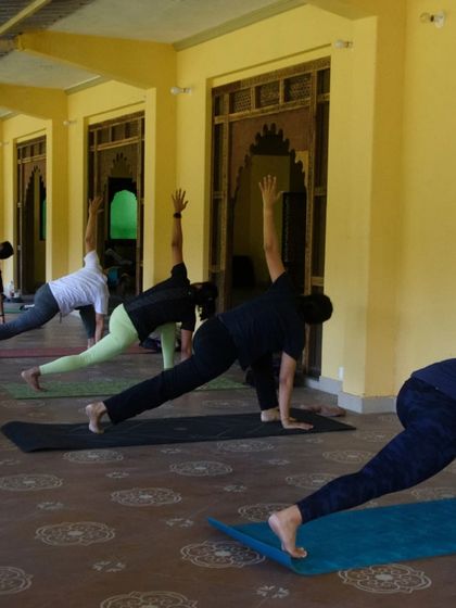 A dynamic moment from our vinyasa flow class, with everyone moving through a revolved side angle pose. The energy of practicing together in a group is truly powerful.