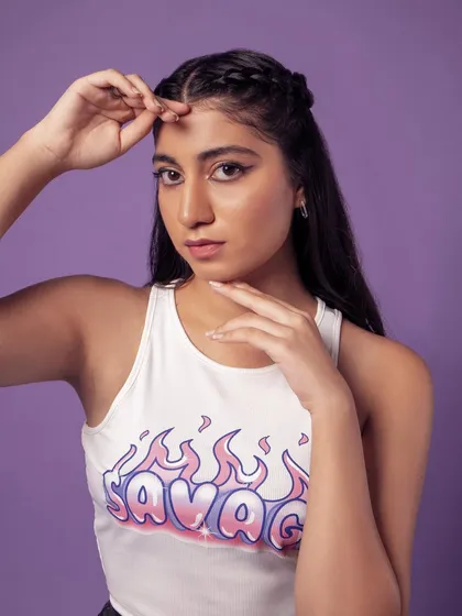 A playful pose that shows off the graphic on the tank top. Perfect for a commercial or street-style look.