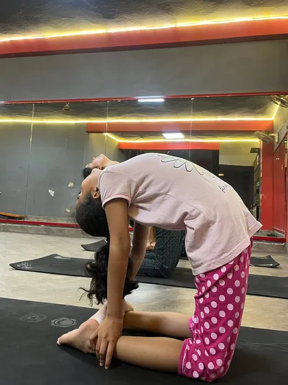 This young yogi is practicing Ustrasana (Camel Pose), a wonderful heart-opener.