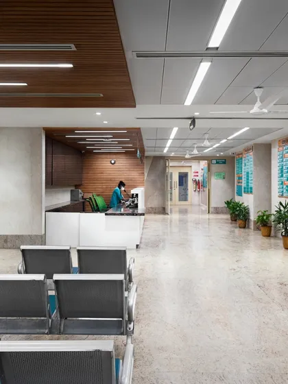 A hospital waiting area should be a space of calm, not anxiety. We achieved this through a clean, intuitive layout, warm materials like the wood-paneled ceiling, and soft, indirect lighting. The design minimizes clutter and noise, creating a serene environment that supports patient well-being from the moment they arrive.