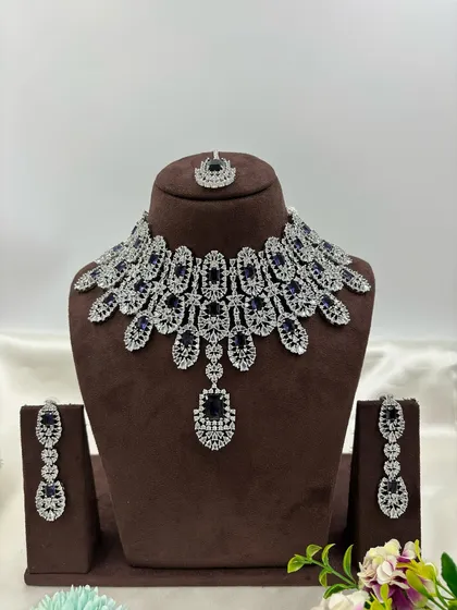 The same full-collar AD necklace design with blue stones.
