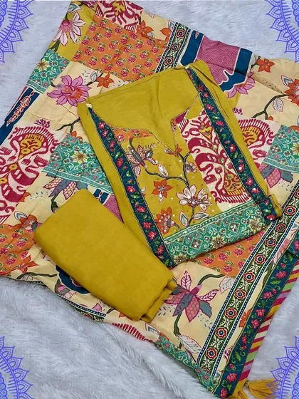 A vibrant yellow unstitched dress material with a digital print dupatta. The patchwork-style print on the dupatta adds a modern and artistic touch to this festive set.