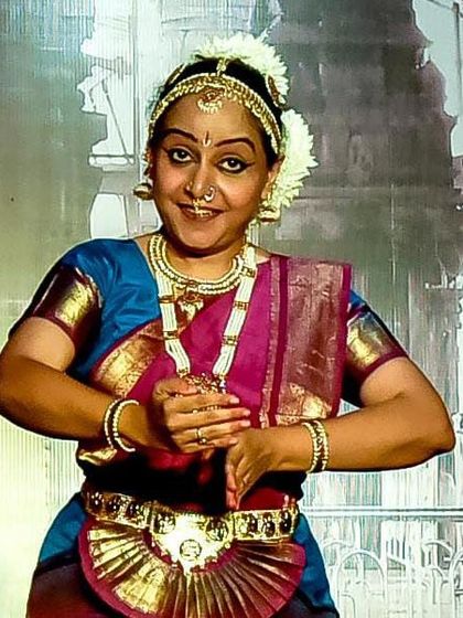 A senior Bharatanatyam artist in a classic pose, adorned in traditional temple jewelry and costume. We teach our students the importance of authenticity in presentation.