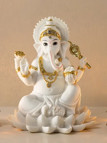 This beautifully detailed sculpture of Ganesh Ji, crafted from pristine white resin with delicate gold accents, brings a sense of peace and blessings. It's an essential piece from my Divinity Collection, perfect for creating a serene focal point in your home, especially during festive seasons.