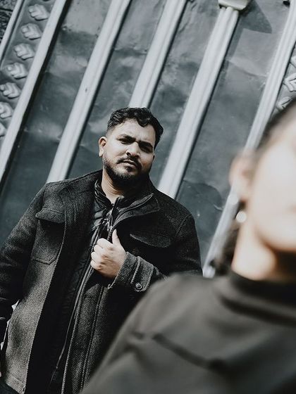 An artistic, moody shot with the bride out of focus in the foreground, creating a sense of depth and mystery.