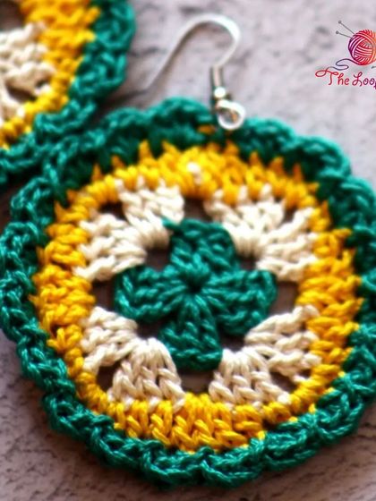 A close-up of the intricate granny square pattern in these colorful crochet earrings.