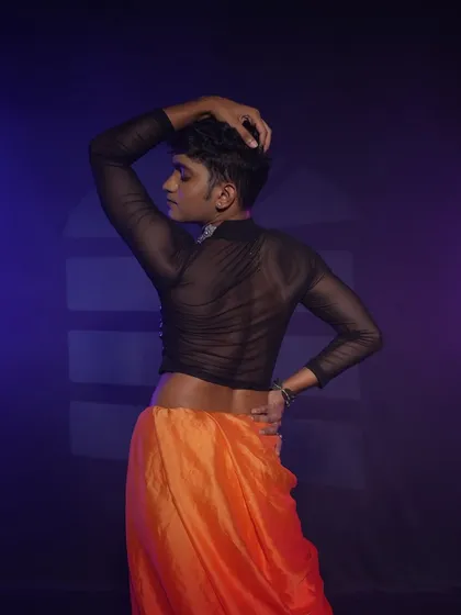 A shot from the back, showing the complete look including the sheer top. Even the back and shoulders are considered for a full performance look.