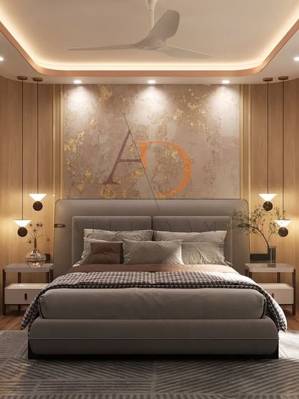 A full view of the master bedroom, centered on the textured feature wall with gold leaf accents and a tufted grey upholstered bed.