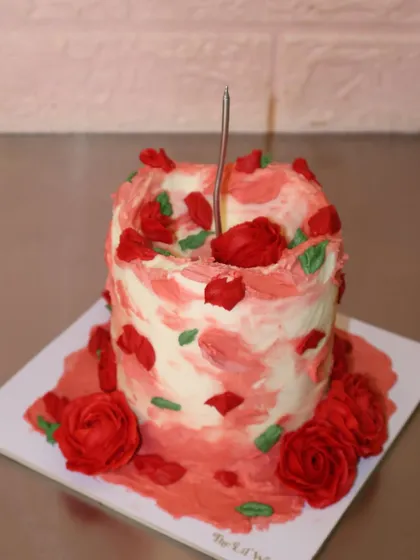 Because love deserves to be celebrated in every bite. A close-up of our rustic red rose cake, ready for a birthday celebration.