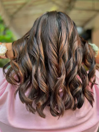 A close-up of this thriving brunette bob. The non-bleach color is rich and healthy, and the waves add a playful touch.