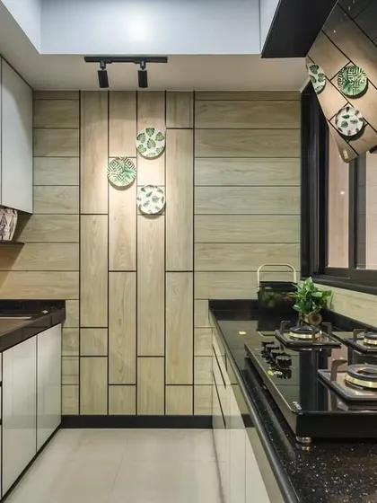 A modular kitchen at Lodha Park, Marquise, with a unique wooden-paneled wall that adds warmth and texture to the space.