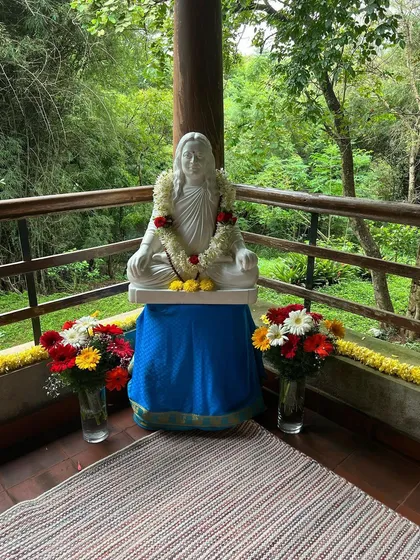 A statue of Mahavatar Babaji, the first in our line of gurus, garlanded with fresh flowers at our retreat. His presence blesses our sacred space.