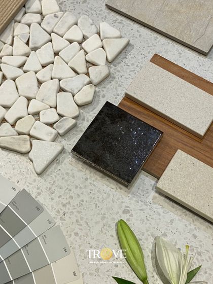 A beautiful mood board showcasing a mix of textures and neutral tones. It combines pebble mosaics, wood grain, and terrazzo look tiles with a coordinating color palette to create a serene and sophisticated design concept.