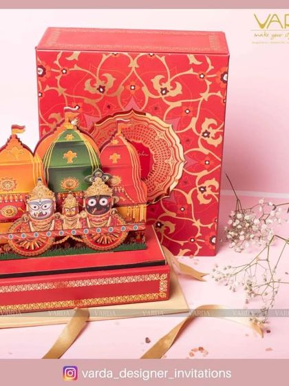 This spectacular wedding invitation box is themed around the Jagannath Rath Yatra. The vibrant, multi-layered pop-up of the deities on their chariots creates a festive and deeply spiritual invitation that is sure to awe your guests.