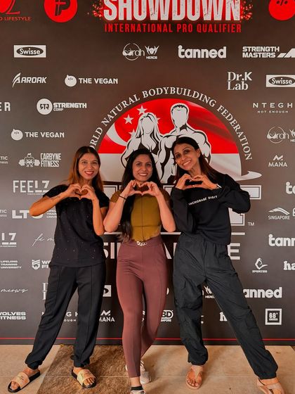 Sharing a moment with my clients before they hit the WNBF Singapore stage. Building a strong, supportive team environment is a core part of my coaching philosophy.