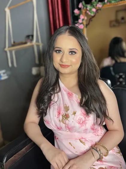 A beautiful, soft party look. The client looks relaxed and confident with her natural-looking makeup and soft hairstyle.
