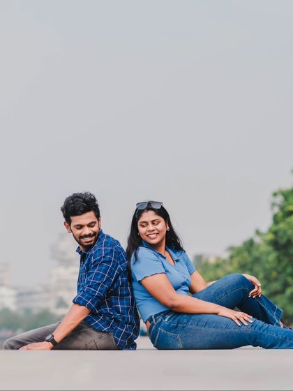 A playful back-to-back pose, capturing the fun and comfortable dynamic of the couple's relationship.