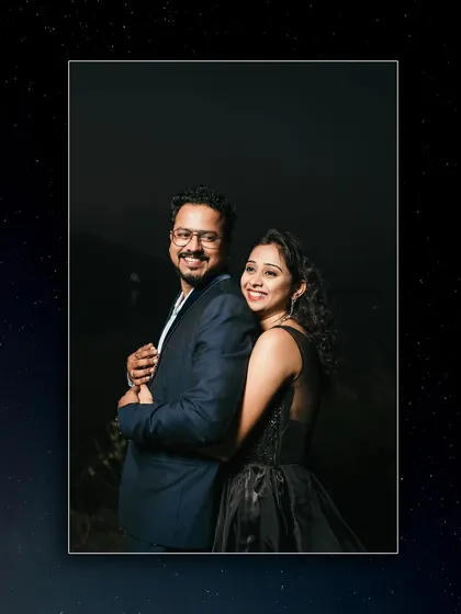 A classic portrait pose against a dark background, highlighting the couple's features and expressions.