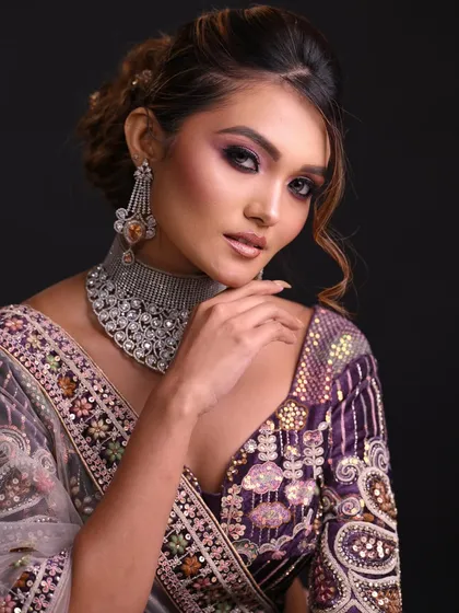 A confident pose showing the full effect of the glamorous makeup and diamond jewelry.
