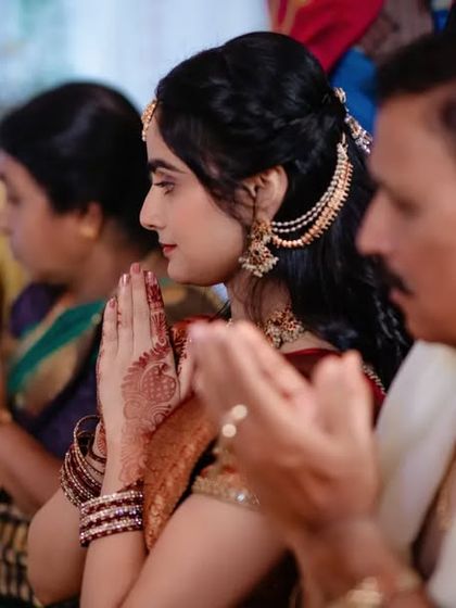 A candid shot of a bride-to-be and her family in prayer during the engagement ceremony. We capture the spiritual and familial aspects of the day.