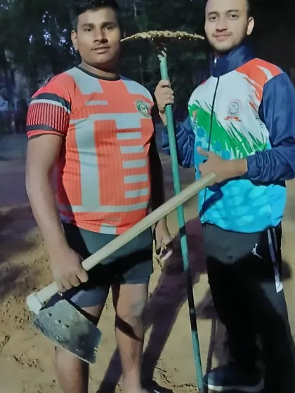 Respect for the ground is the first lesson. Here are our players with the tools used to prepare our mud court.